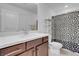 This bathroom features modern cabinets, a sink and a toilet behind a curtain at 7260 Grace Estate Ave, Las Vegas, NV 89113