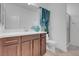Bright bathroom with marble countertops, wood cabinets, and a glass-enclosed shower at 7260 Grace Estate Ave, Las Vegas, NV 89113