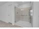 This bathroom showcases a glass shower stall with sleek fixtures and a bench seat at 7260 Grace Estate Ave, Las Vegas, NV 89113