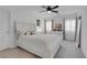This bedroom has lots of bright light and features a ceiling fan and a plush bed at 7260 Grace Estate Ave, Las Vegas, NV 89113