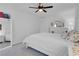 This bedroom has lots of bright light and features a ceiling fan and a plush bed at 7260 Grace Estate Ave, Las Vegas, NV 89113