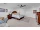 A spacious main bedroom with a ceiling fan, rug and well-placed decor at 7260 Grace Estate Ave, Las Vegas, NV 89113