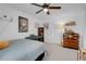 Bright bedroom with a poster, a dresser, and comfortable bedding with a ceiling fan at 7260 Grace Estate Ave, Las Vegas, NV 89113