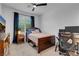Cozy bedroom featuring a comfortable bed, ceiling fan, dark trim and carpeted floors at 7260 Grace Estate Ave, Las Vegas, NV 89113