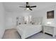 This bedroom has lots of bright light and features a ceiling fan and a plush bed at 7260 Grace Estate Ave, Las Vegas, NV 89113