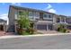 Charming two-story home showcasing a stone facade, three-car garage, and manicured landscaping at 7260 Grace Estate Ave, Las Vegas, NV 89113