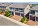 Attractive two-story home showcases a brick driveway, manicured lawn, and tasteful landscaping for a welcoming curb appeal at 7260 Grace Estate Ave, Las Vegas, NV 89113