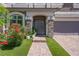 Close up of the front door with stone accents and manicured flower beds at 7260 Grace Estate Ave, Las Vegas, NV 89113