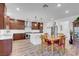 Open kitchen boasts white countertops, stainless appliances, and eat-in island at 7260 Grace Estate Ave, Las Vegas, NV 89113
