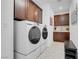 Well-organized laundry room featuring modern washer, dryer, and sleek cabinetry at 7260 Grace Estate Ave, Las Vegas, NV 89113