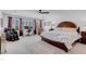 Spacious main bedroom suite with large windows and a ceiling fan at 7260 Grace Estate Ave, Las Vegas, NV 89113