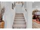 Carpeted staircase with white railing leading to the upper level of the home at 7260 Grace Estate Ave, Las Vegas, NV 89113