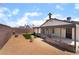 Spacious backyard featuring gravel landscaping, small grass lawn, patio, and privacy wall, perfect for outdoor relaxation at 806 Fireweed Dr, Henderson, NV 89002