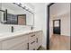 Modern bathroom with double sink, white cabinets, and black hardware, complemented by elegant countertops at 806 Fireweed Dr, Henderson, NV 89002