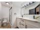 Modern bathroom with double sinks, marble countertops, sleek lighting, and a walk-in shower at 806 Fireweed Dr, Henderson, NV 89002
