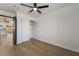 Cozy bedroom features wood-look floors, a ceiling fan, a closet and neutral decor at 806 Fireweed Dr, Henderson, NV 89002