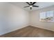 Well-lit bedroom featuring wood-look floors, a ceiling fan, and bright natural light at 806 Fireweed Dr, Henderson, NV 89002