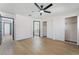 Spacious bedroom with sleek ceiling fan, hardwood floors, and modern closet doors at 806 Fireweed Dr, Henderson, NV 89002