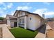 Single-story home with two-car garage, small lawn and stone landscaping around the side of the home at 806 Fireweed Dr, Henderson, NV 89002