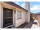 Close up of the front door, a trimmed bush, and a security window on the side of the house at 806 Fireweed Dr, Henderson, NV 89002