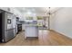 Modern kitchen with light floors, white cabinets, stainless appliances, granite counters and access to the backyard at 806 Fireweed Dr, Henderson, NV 89002