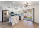 Updated kitchen featuring new floors, white cabinets, stainless appliances, modern backsplash and granite counters at 806 Fireweed Dr, Henderson, NV 89002