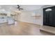 A bright and airy open-concept living room features new light floors, white walls and updated lighting at 806 Fireweed Dr, Henderson, NV 89002