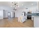 Open floor plan with a combined living room and kitchen area with marble countertops and stainless appliances at 806 Fireweed Dr, Henderson, NV 89002