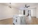 Bright living room featuring hardwood floors, a modern chandelier, and a sleek ceiling fan at 806 Fireweed Dr, Henderson, NV 89002