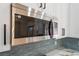 Stainless steel microwave in a modern kitchen with white cabinets and stylish blue backsplash at 806 Fireweed Dr, Henderson, NV 89002