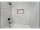 Marble-style tile shower featuring a built-in soap and shampoo niche and sleek black fixtures at 806 Fireweed Dr, Henderson, NV 89002