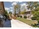 Landscaped backyard featuring lush green grass, desert landscaping, patio furniture, and a stainless steel BBQ grill at 820 Bernini St, Las Vegas, NV 89144