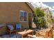 Secluded backyard patio with wooden furniture set on an accent rug at 820 Bernini St, Las Vegas, NV 89144