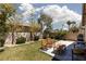 Backyard featuring lush green grass, desert landscaping, string lights and patio furniture at 820 Bernini St, Las Vegas, NV 89144