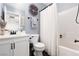 Bathroom featuring a toilet, vanity with sink, and tub with shower and decorative lavender wreath at 820 Bernini St, Las Vegas, NV 89144