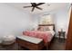 Bright main bedroom with dark wood floors, a ceiling fan and a large window at 820 Bernini St, Las Vegas, NV 89144