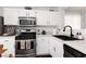 Kitchen featuring stainless steel appliances, white cabinets, a dark sink and countertops at 820 Bernini St, Las Vegas, NV 89144