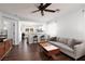 Bright living room showcasing wood floors, an open concept, and views of the kitchen and dining area at 820 Bernini St, Las Vegas, NV 89144