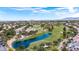 Stunning aerial view showcases the community's golf course, lake, and lush landscape at 8800 Cortile Dr, Las Vegas, NV 89134