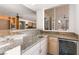 Home bar features granite countertops, sink, beverage cooler, and seamless access to adjacent room at 8800 Cortile Dr, Las Vegas, NV 89134