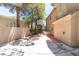 A backyard with a basketball court offers an outdoor space for sports and recreation surrounded by mature trees and landscaping at 8800 Cortile Dr, Las Vegas, NV 89134
