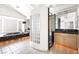 Bright bathroom featuring a tub, walk-in shower, and dual sink vanities at 8800 Cortile Dr, Las Vegas, NV 89134