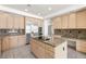 Modern kitchen features stainless steel appliances, granite countertops, and a center island cooktop at 8800 Cortile Dr, Las Vegas, NV 89134