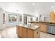 Kitchen with island, tile floors, stainless steel appliances, and backyard pool view at 8800 Cortile Dr, Las Vegas, NV 89134