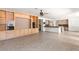 Large living area with built-in cabinets, tile flooring, and views of the kitchen at 8800 Cortile Dr, Las Vegas, NV 89134