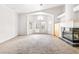 Spacious living room with neutral carpet, fireplace, and double doors at 8800 Cortile Dr, Las Vegas, NV 89134