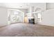 Bright living room with fireplace, carpet floors, and natural light from large windows at 8800 Cortile Dr, Las Vegas, NV 89134