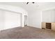 Bright living room with neutral carpeting, arched doorway, and built-in cabinets at 8800 Cortile Dr, Las Vegas, NV 89134