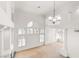 Bright living room featuring vaulted ceilings, large windows, and a modern chandelier at 8800 Cortile Dr, Las Vegas, NV 89134