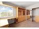 Office featuring built-in desk, cabinets, and mirrored sliding door at 8800 Cortile Dr, Las Vegas, NV 89134